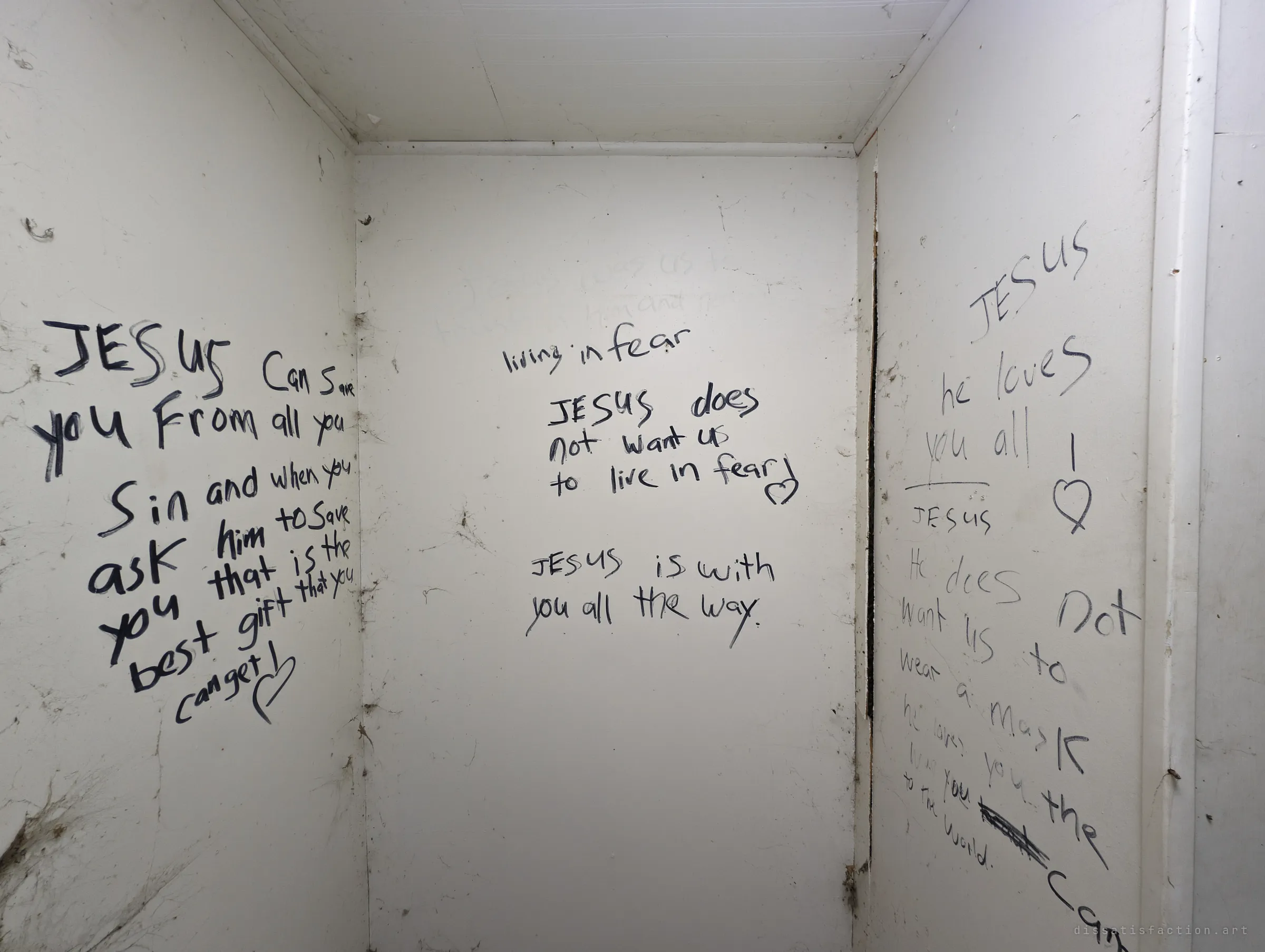 A narrow white closet whose three walls are covered in marker messages about faith and not living in fear. Even the smallest space in the house was written on.