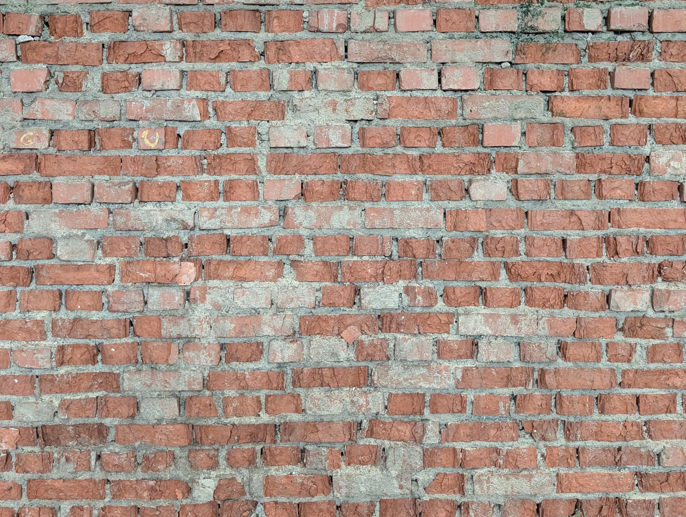 A close, flat view of weathered red brickwork with crumbling mortar. A texture study of the old walls.