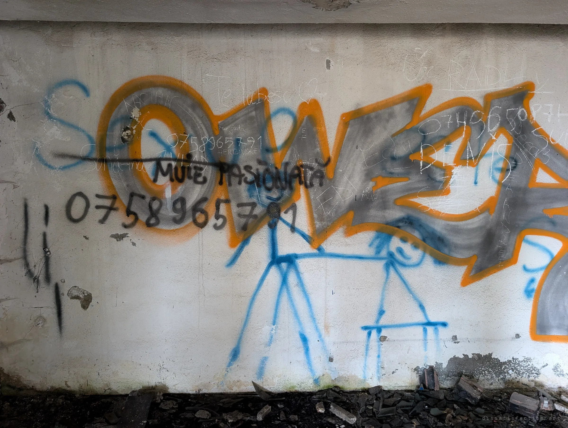 An orange and grey graffiti piece overlaid with stick figures, scratched love notes and crude messages. Layers of visitors have written over each other.