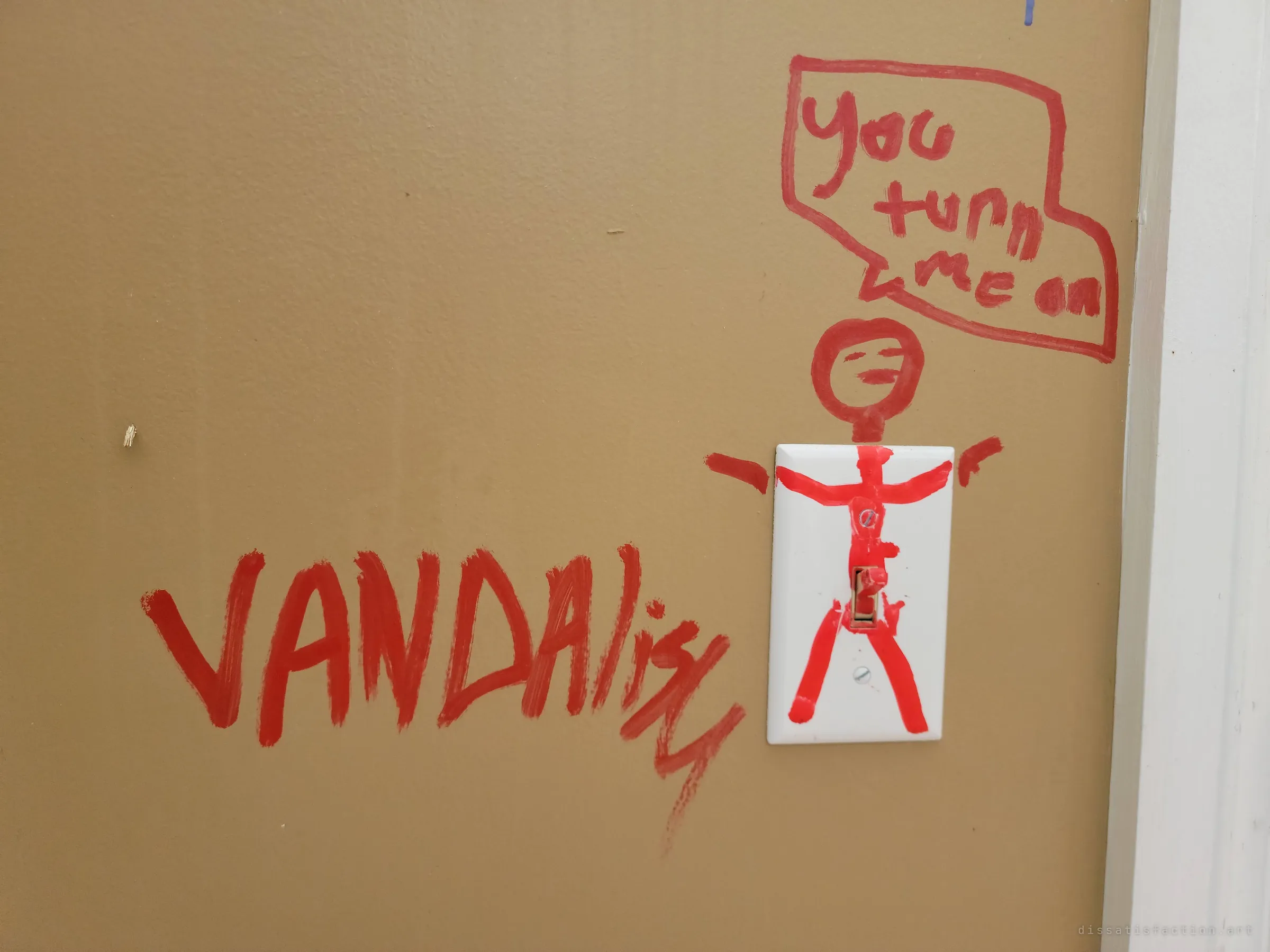 A red stick figure painted around a light switch says 'you turn me on', with the word 'vandalism' daubed beside it.