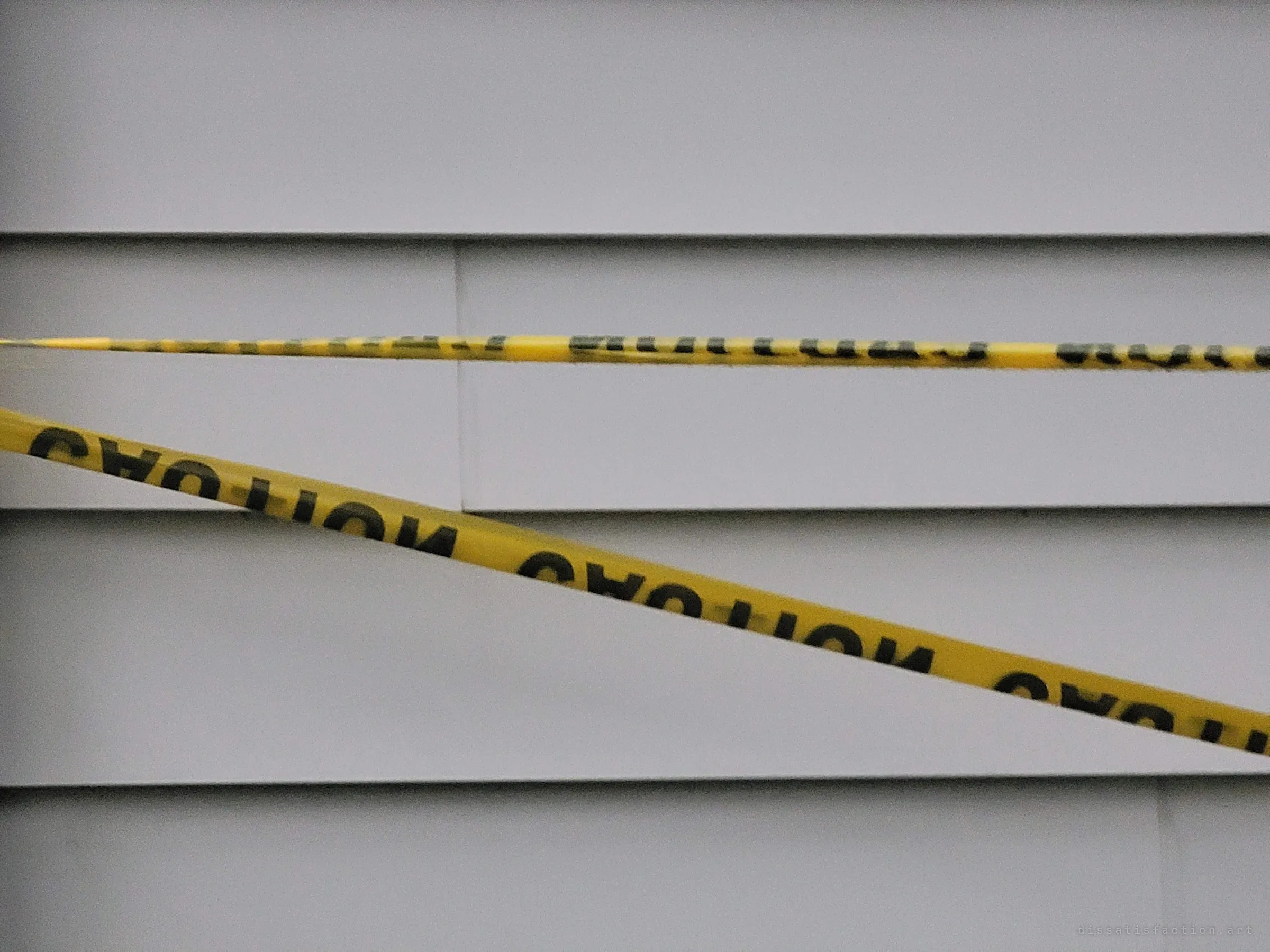 Two strands of yellow caution tape cross the house's white siding, the plainest sign that the place is sealed off.