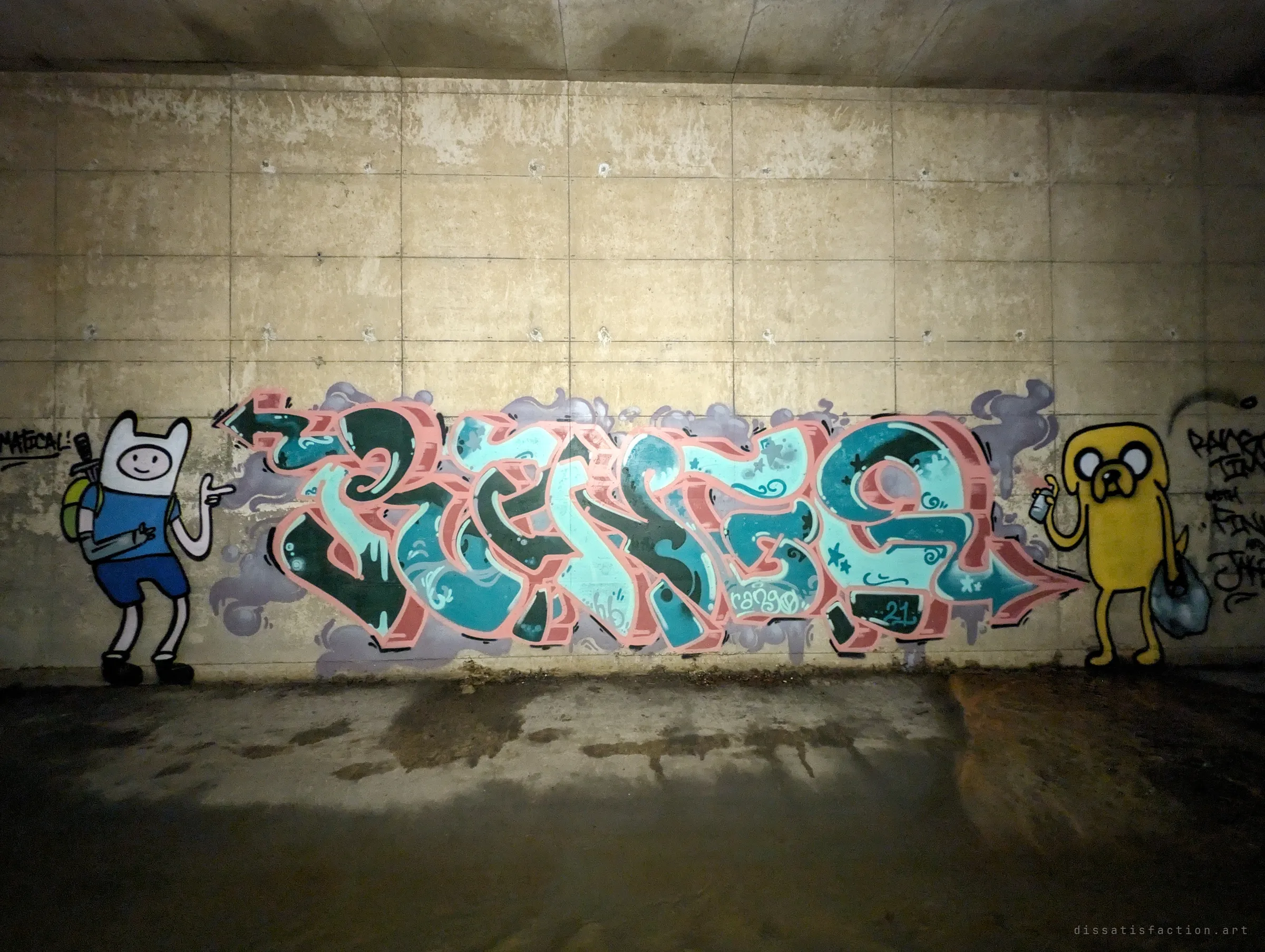 A teal and pink letter piece flanked by two cartoon characters, one holding a spray can, under the low concrete ceiling. Torchlight falls across the damp, muddy floor.