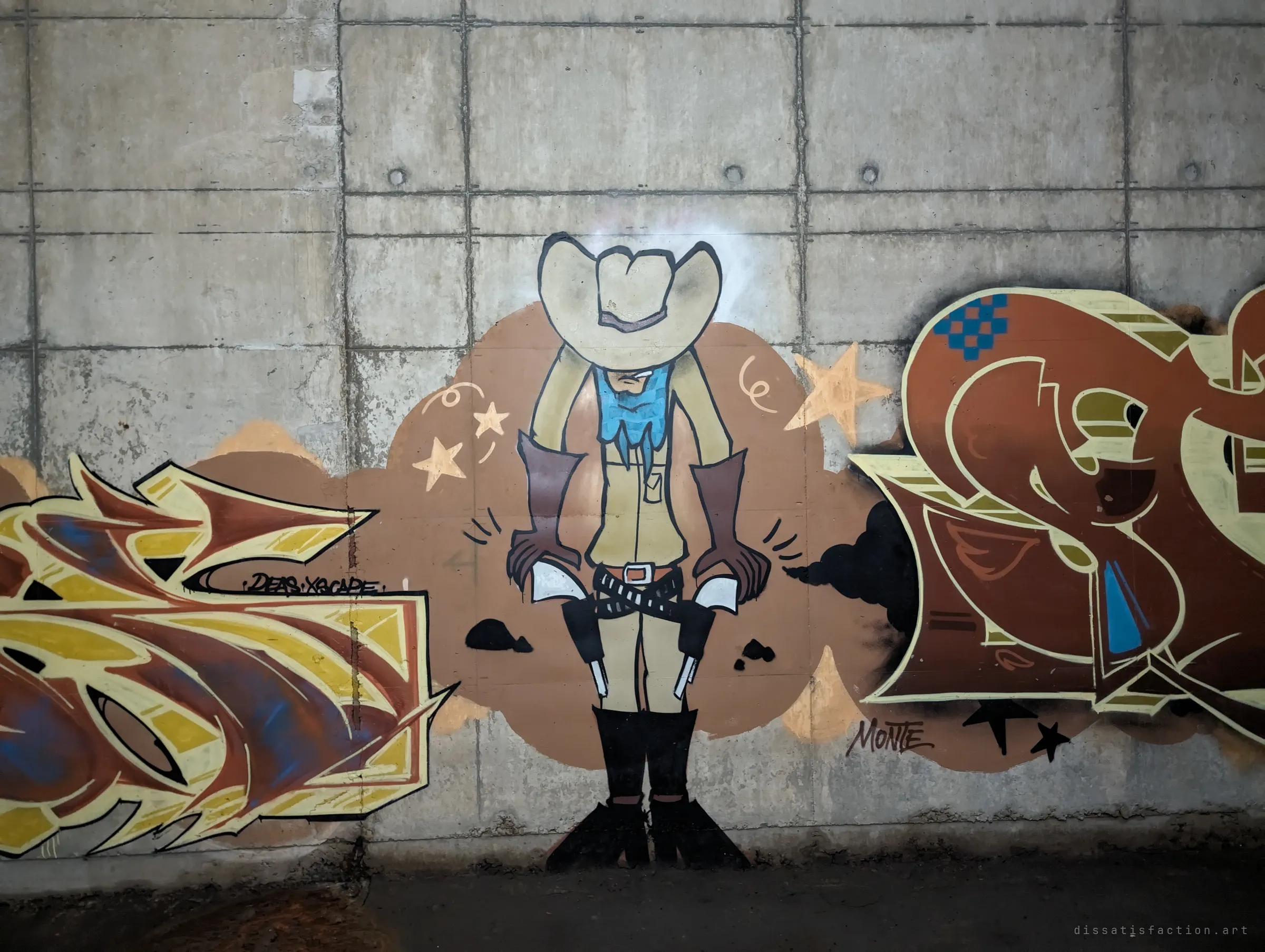 A lanky cowboy character with his hat pulled low stands between two brown and cream letter pieces. Board-marked concrete panels and tie holes frame the painting.