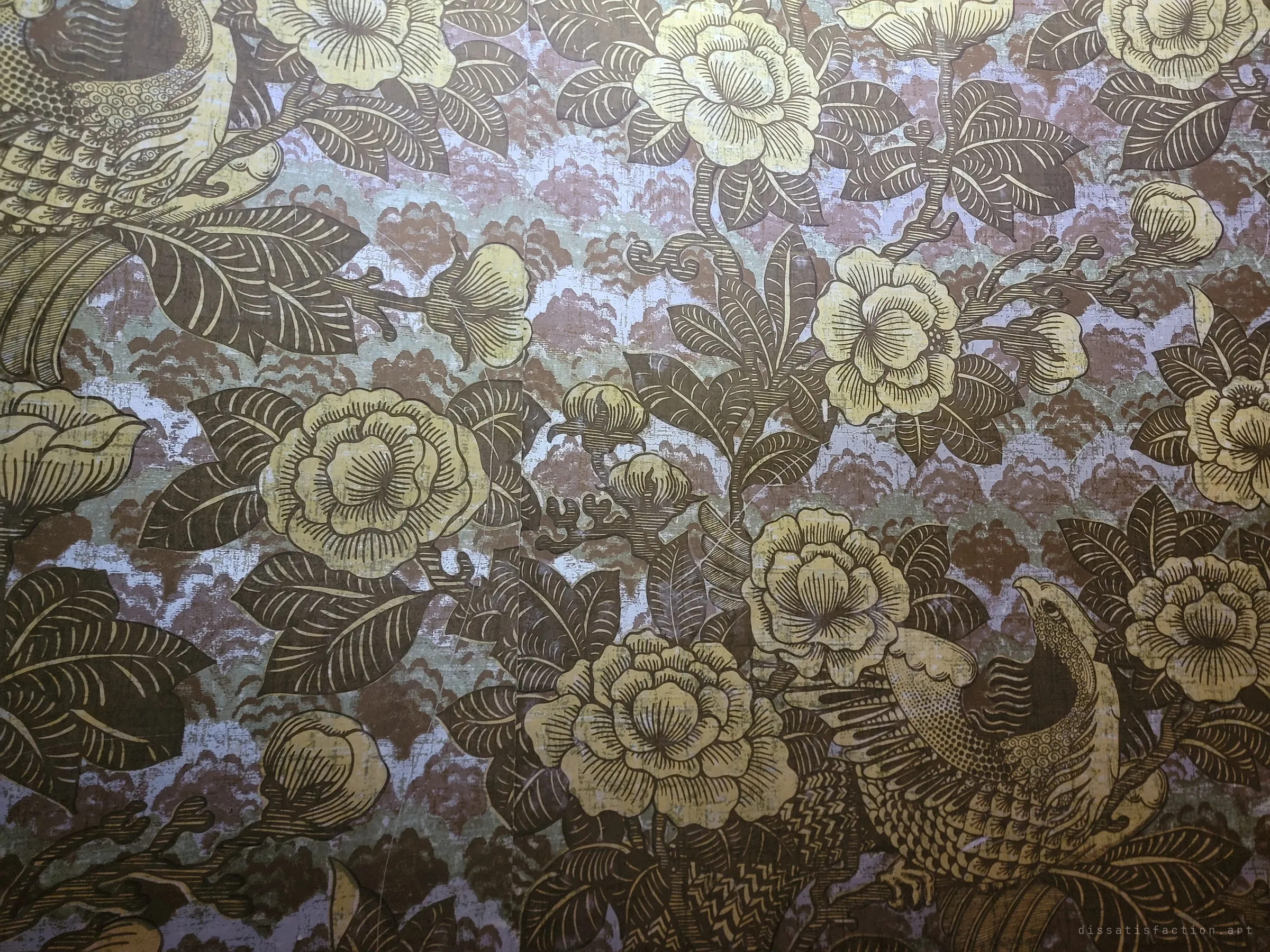 Close-up of dark metallic wallpaper with engraved-style peonies and birds over a lilac and brown ground, one of the house's many patterned rooms.
