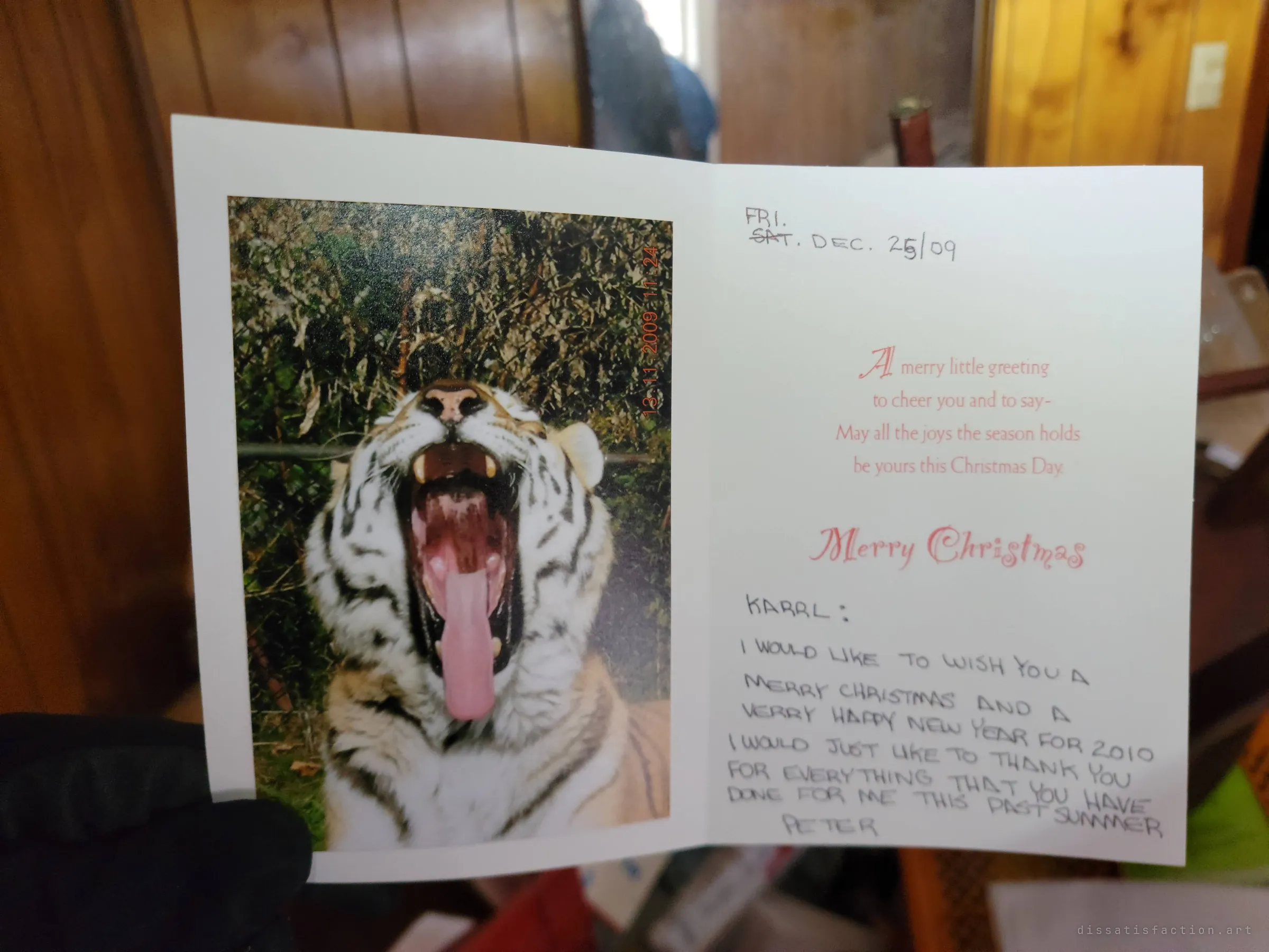 A Christmas card with a yawning tiger on the front, opened to a handwritten thank-you note from 2009 that was never opened by its recipient.