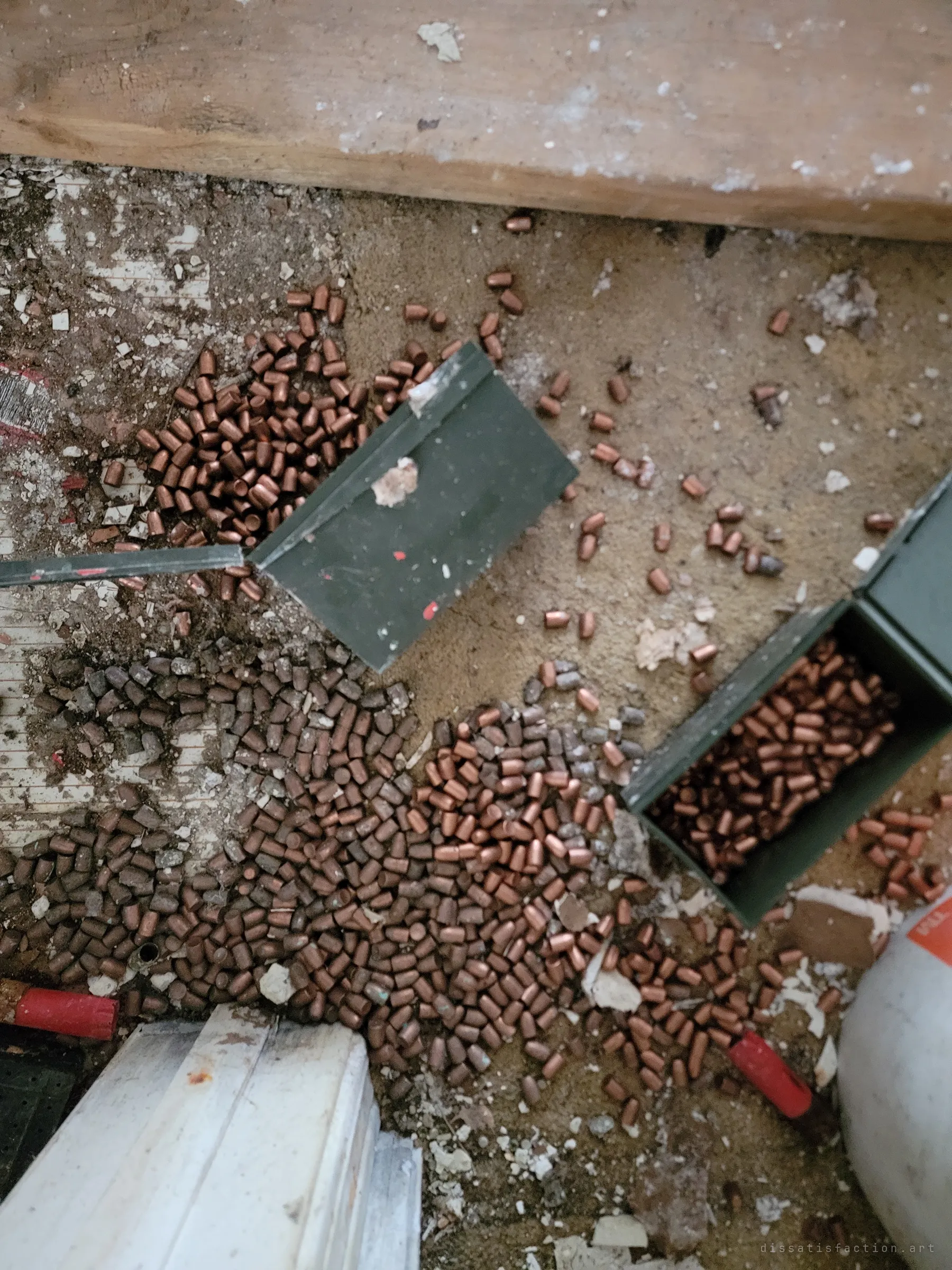 Hundreds of loose copper bullet heads spill from green ammo cans across the floor, the reloading stockpile at the heart of this prepper house.